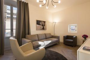 a living room with a couch and a chair at Apartments Florence - Duomo Contemporary in Florence