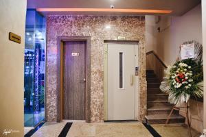 a front door of a building with a flower wreath at El Mena Beach in Ras El Bar