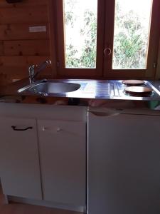 a kitchen with a sink and a window at Village.insolite in Montagny-sur-Grosne