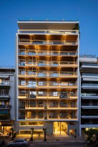 a large white building with a parking lot in front of it at Coco-mat Athens BC in Athens