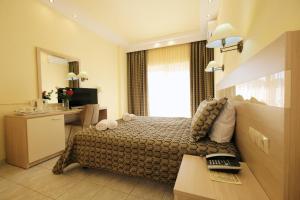 a hotel room with a large bed and a desk at Hotel Diamantidis in Myrina
