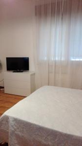 a bedroom with a bed and a flat screen tv at orlando in Porto Garibaldi
