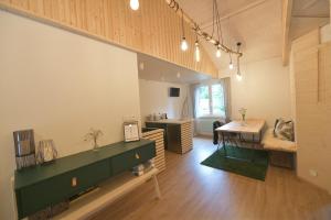a living room with a desk and a table at NORDIK 1496 in Vysoké Tatry