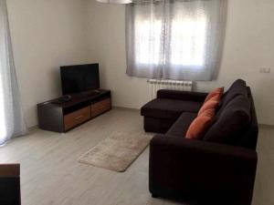 a living room with a couch and a flat screen tv at Casa Luna in Pataias