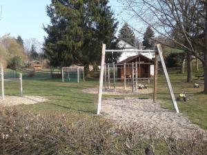 a playground with a swing set in a park at Kreuzdellenhof _ Ferienwohnung in Hembach