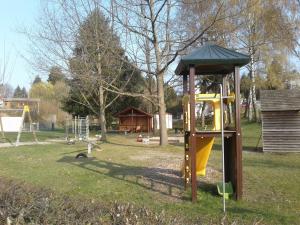 a park with a playground with a yellow slide at Kreuzdellenhof _ Ferienwohnung in Hembach