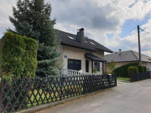 a house with a fence in front of it at Apartman Max in Sveti Ivan Zelina