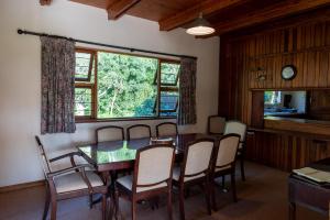 a dining room with a table and chairs and a window at Natures Way Farmhouse in The Crags