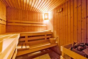 a wooden sauna with a bench in it at TUI MAGIC LIFE Penelope Beach - Families & Couples in Midoun
