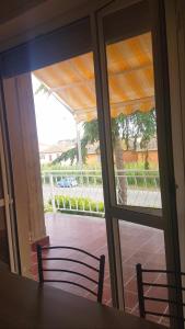 a sliding glass door looking out onto a patio at Apt. 7 - Villa dei Pini in Ameglia