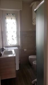 a bathroom with a sink and a toilet and a window at Apt. 7 - Villa dei Pini in Ameglia