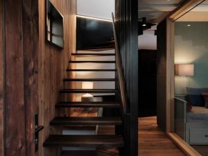 una escalera en una casa con paredes de madera en Loft im Stadl, en Innervillgraten