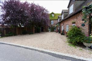 an empty driveway in front of a brick house at Hanger Down House Bed and Breakfast in Arundel