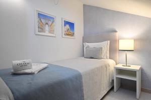 
a hotel room with a bed, desk, and lamp at My Charm Lisbon Suites in Lisbon
