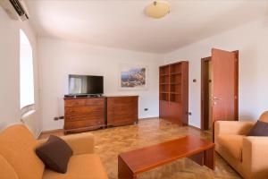 a living room with a couch and a tv at Apartment Kovacevic Old Town in Budva