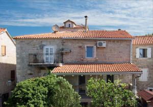a large brick building with a balcony on top of it at Apartment Kovacevic Old Town in Budva