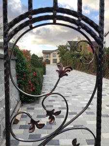 a wrought iron gate with a view of a driveway at Eden Blue in Costinesti
