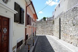 an alley with a stone wall and a building at Kame House in Vila Nova de Gaia