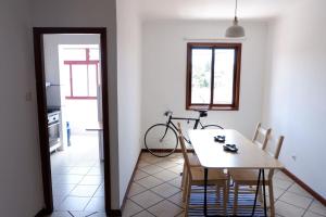 a dining room with a table and a bike at Kame House in Vila Nova de Gaia