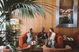 a group of three people sitting on a couch at Hotel Angeleno in Los Angeles