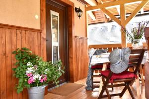 a person sitting at a table on a porch at Apartment Ravnik in Bled