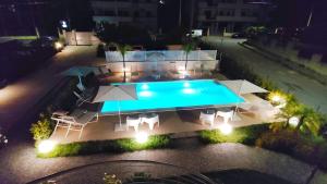 an overhead view of a swimming pool at night at Centurio luxury rooms in Tropea