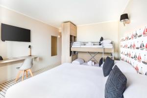 a hotel room with a bed and a desk at Best Western Plus Antibes Riviera in Antibes