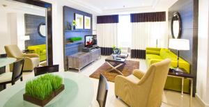 a living room with a yellow couch and a table at Astoria Plaza in Manila