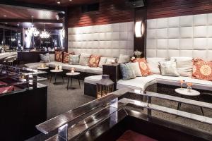 a lobby with a couch and tables and a bar at Hotel Angeleno in Los Angeles