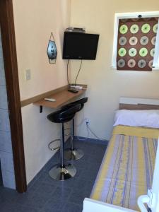 a bedroom with a desk and a bed and a desk with a computer at Apartments Medusa in Makarska