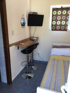 a room with a desk and a bed and a desk with a computer at Apartments Medusa in Makarska