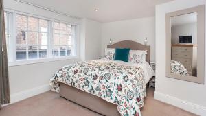 a bedroom with a bed and a mirror at The King's- Gorgeous City Centre Apartment in York