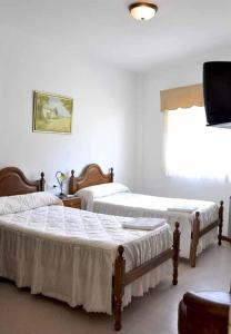 Кровать или кровати в номере Pensión Costiña