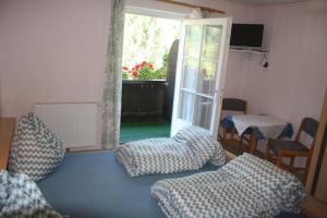 a living room with a couch and a sliding glass door at Casa da Honna in Matrei in Osttirol