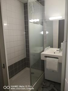 a bathroom with a shower and a sink at Ibis Budget Cergy St Christophe in Cergy