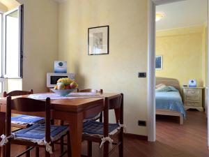 a dining room with a table and a bedroom at House Blue Sky by Holiday World in Genoa