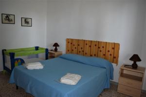 Un pat sau paturi într-o cameră la Casevacanze Le Muse