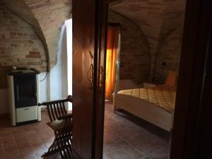 a bedroom with a bed and a chair in a room at B&B La Casa in Campagna in Collecorvino