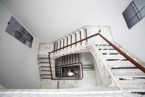 a staircase in a building with a stair case at Plazuela del Carbón Suites in Cádiz