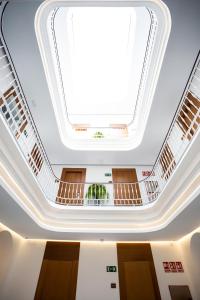a large skylight in the ceiling of a building at Plazuela del Carbón Suites in Cádiz