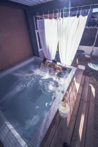 two people in a jacuzzi in a hot tub at The Old Hotel Ravel Centre in Clermont-Ferrand