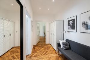 a room with a white wall and a black and white floor at Apartment Slavikova 11 in Prague