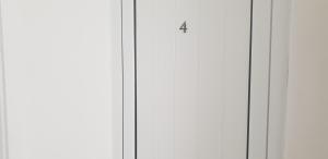 a white cabinet with the number four on it at Свети Никола in Sinemorets