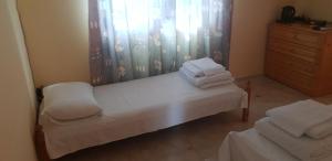 a bedroom with a bed with white towels on it at Свети Никола in Sinemorets