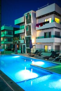 a building with a swimming pool in front of a building at Boutique Apartments Ad Astra in Bibinje