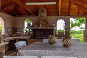 a kitchen with a table with two vases on it at Afroditi Hotel in Paralia Katerinis