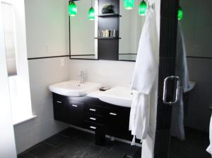 a bathroom with a sink and a mirror at BlancNoir Bed & Breakfast in Baltimore +24 photos