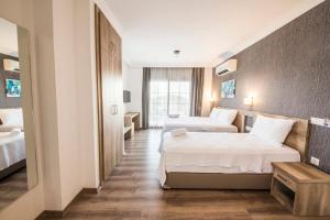 a hotel room with two beds and a window at dekatria rooms&aparts in Kas