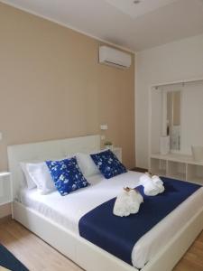 a bedroom with a bed with two stuffed animals on it at Sicitaly taormina in Taormina