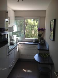 a kitchen with a window and a counter top at L'appart des lutins in Pornic
